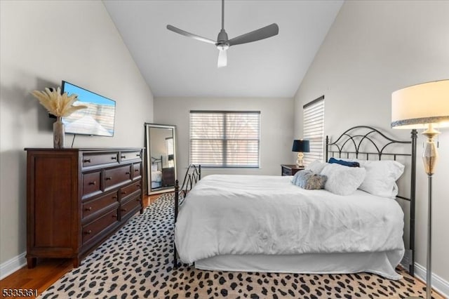 bedroom featuring hardwood / wood-style flooring, high vaulted ceiling, and ceiling fan