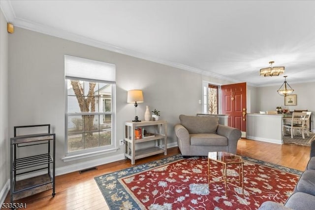 living room with hardwood / wood-style flooring and crown molding