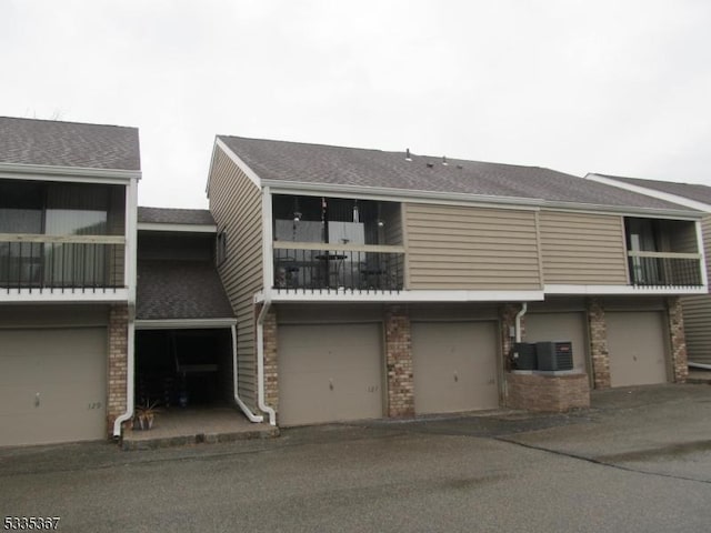 view of front of property with a balcony and central AC