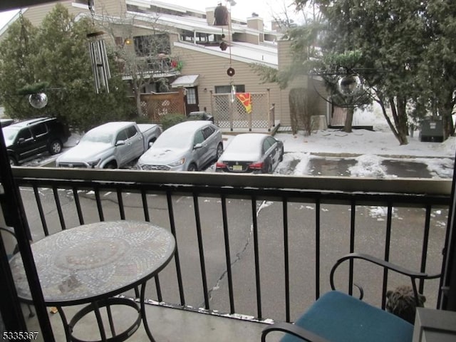 view of snow covered back of property