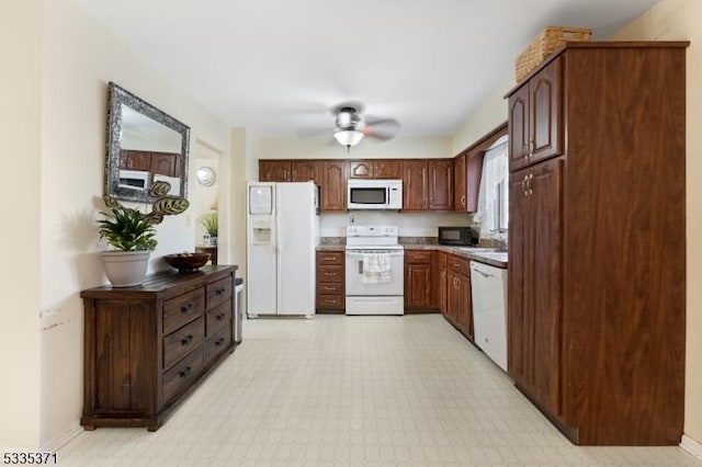 kitchen with sink, white appliances, dark brown cabinets, and ceiling fan