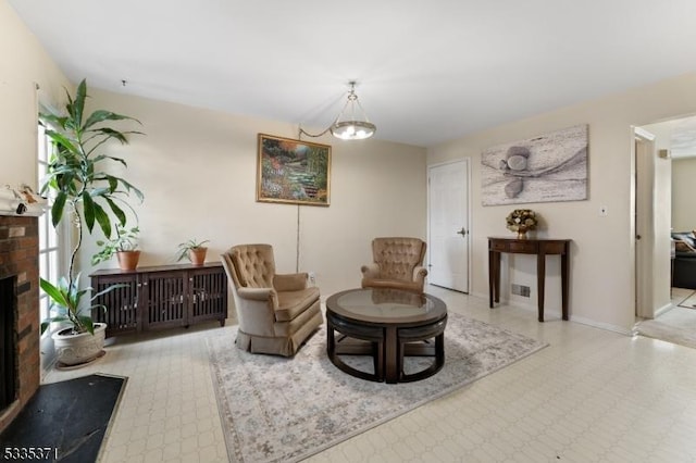 sitting room featuring a brick fireplace