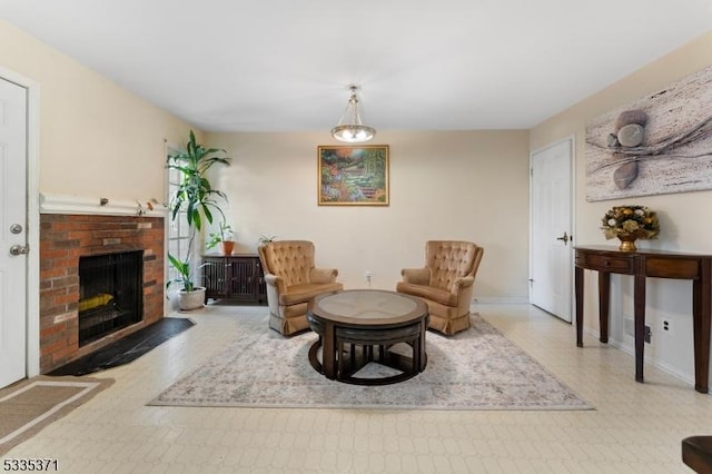 living area featuring a brick fireplace