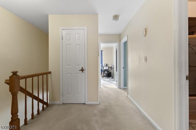 hall featuring light colored carpet