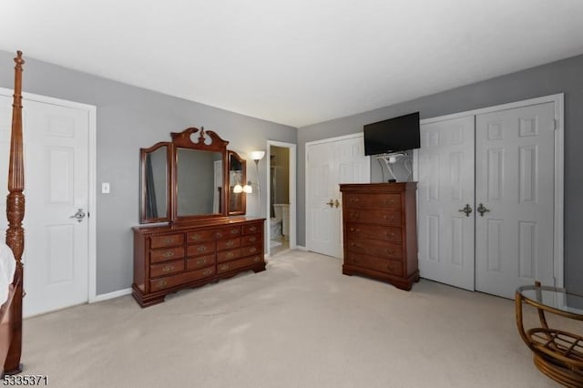 bedroom with light carpet and a closet