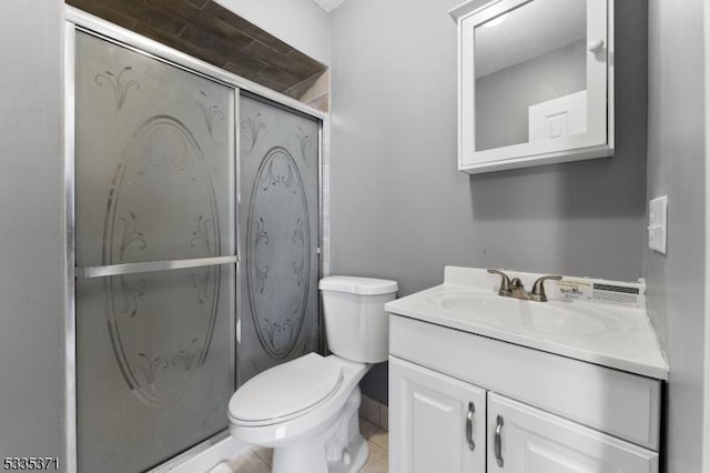 bathroom with vanity, toilet, an enclosed shower, and tile patterned flooring