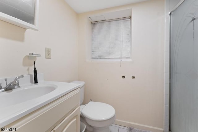 bathroom featuring walk in shower, vanity, toilet, and tile patterned flooring