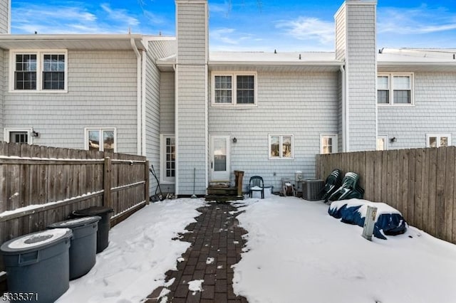 view of snow covered rear of property