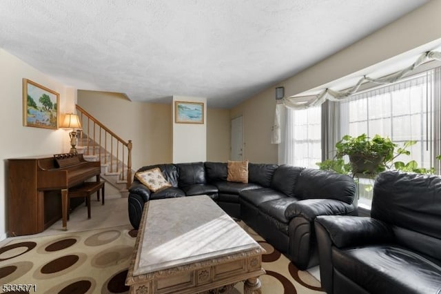 carpeted living room with a textured ceiling