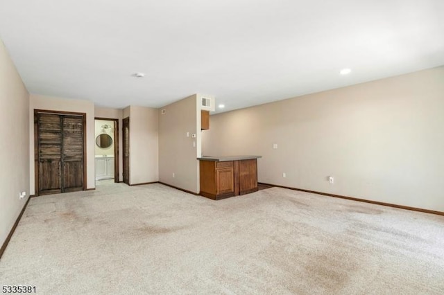 unfurnished living room with light carpet