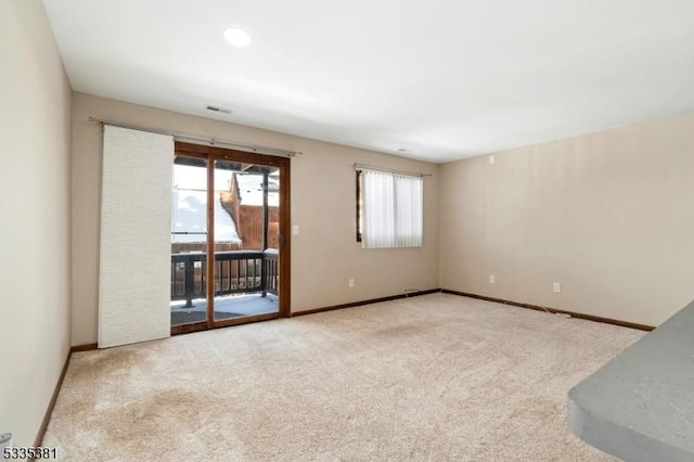 carpeted empty room featuring plenty of natural light