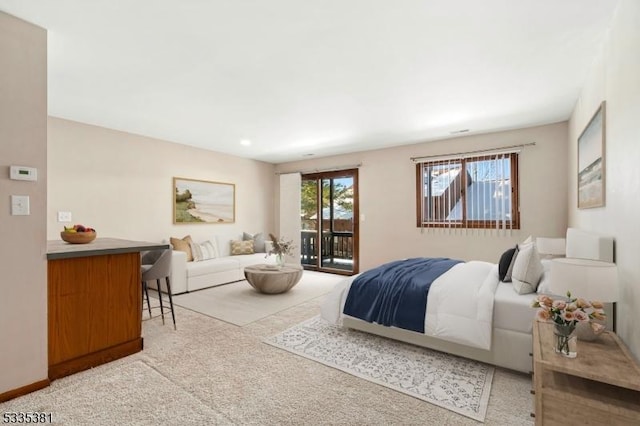 bedroom featuring light carpet and access to outside