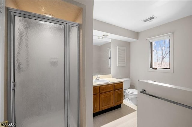 bathroom with vanity, toilet, and walk in shower