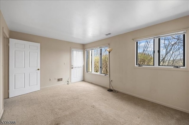 unfurnished bedroom featuring light carpet