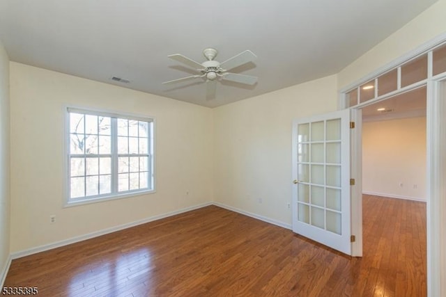 spare room with hardwood / wood-style floors and ceiling fan