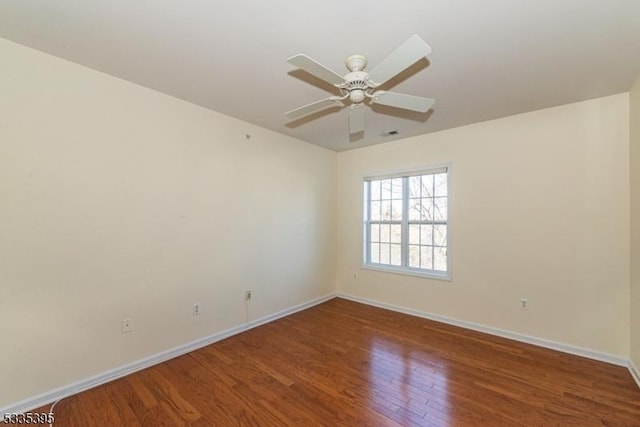 spare room with wood-type flooring and ceiling fan