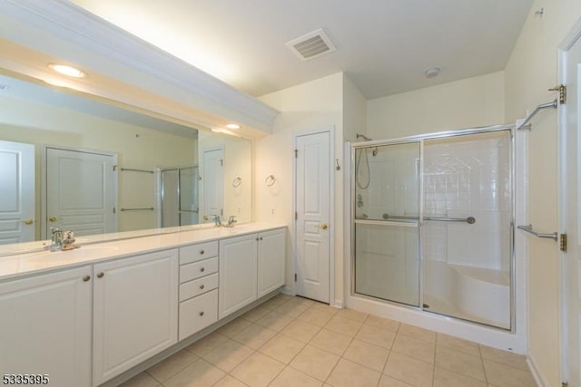 bathroom with vanity, tile patterned floors, and a shower with door