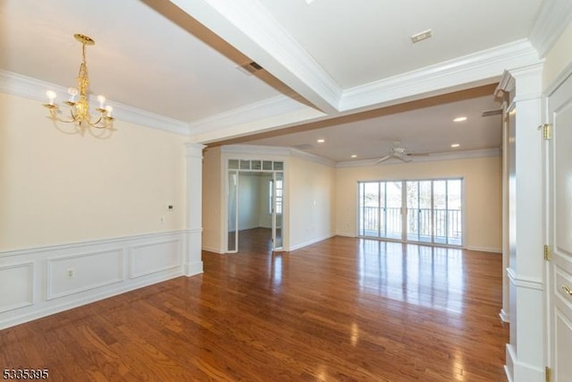 spare room featuring hardwood / wood-style flooring, crown molding, ceiling fan with notable chandelier, and decorative columns