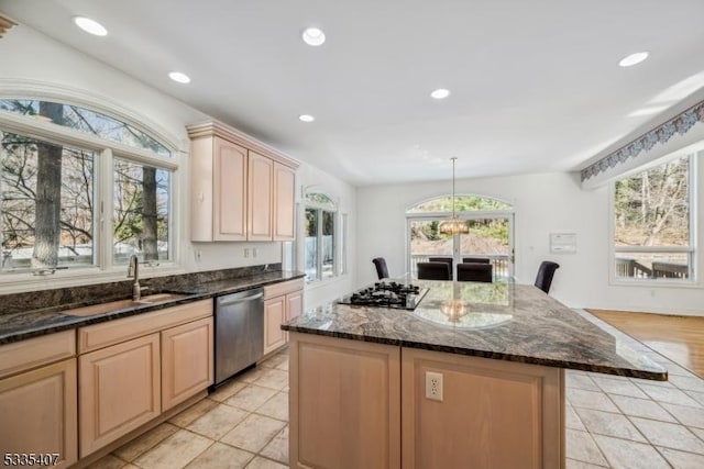 kitchen with pendant lighting, sink, a center island, light brown cabinetry, and stainless steel dishwasher