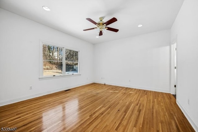 unfurnished room featuring hardwood / wood-style flooring and ceiling fan