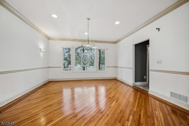 unfurnished dining area featuring ornamental molding and wood-type flooring