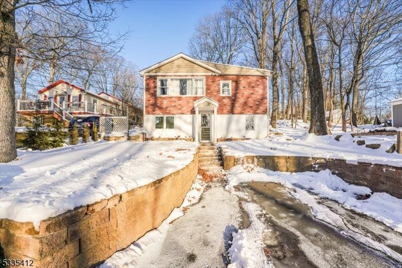 view of snow covered back of property