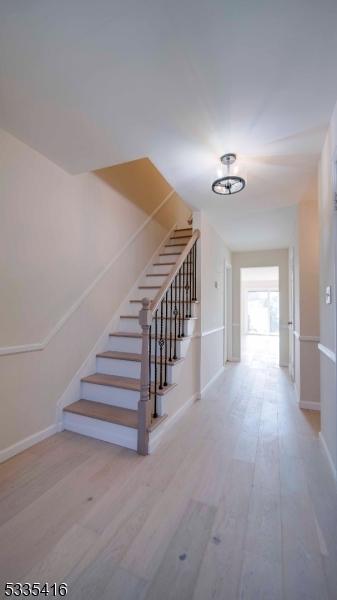 hallway with hardwood / wood-style floors