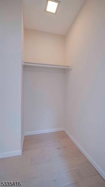 walk in closet featuring light hardwood / wood-style floors