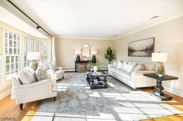 living room featuring crown molding, a baseboard heating unit, and hardwood / wood-style floors