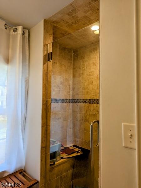 bathroom with a shower with shower door