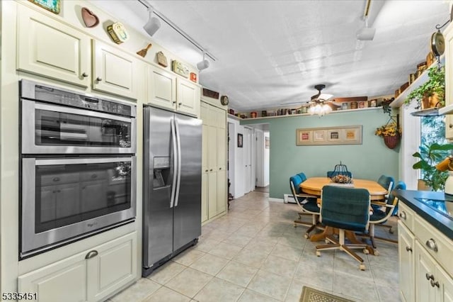 kitchen featuring ceiling fan, stainless steel appliances, light tile patterned flooring, and rail lighting