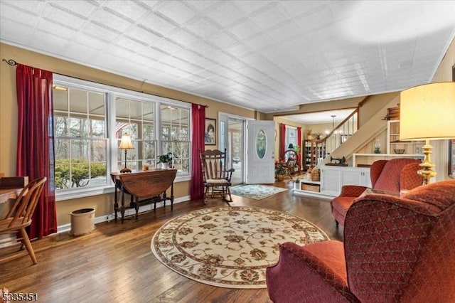 interior space with stairway, wood finished floors, and baseboards