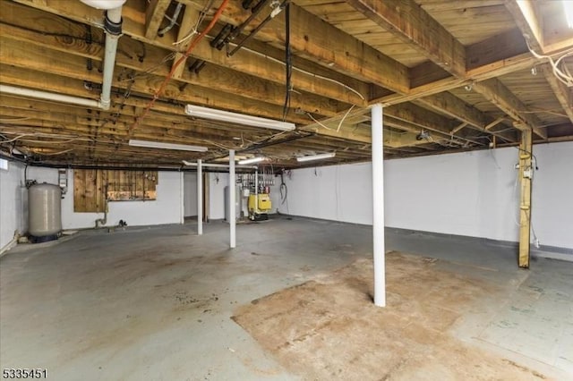 unfinished basement with gas water heater and a heating unit