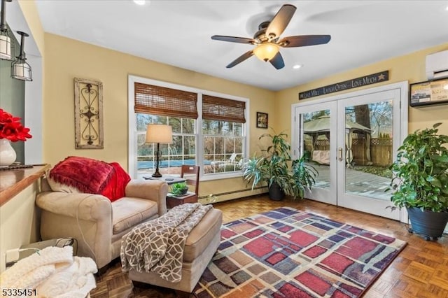 living area with ceiling fan, recessed lighting, french doors, baseboard heating, and a wall mounted air conditioner