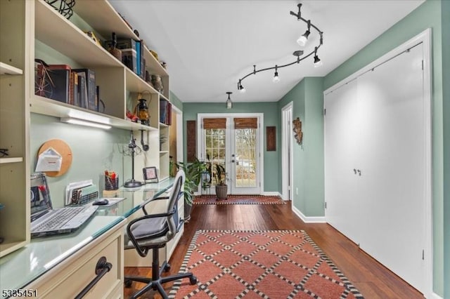 office space with dark wood-style floors, french doors, built in desk, and track lighting