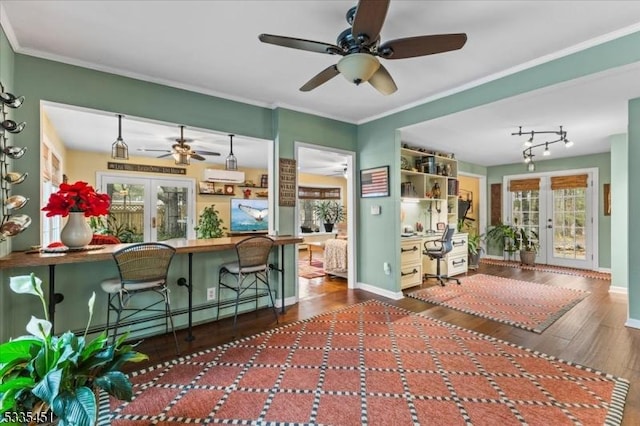 kitchen featuring ornamental molding, french doors, wood finished floors, and baseboards