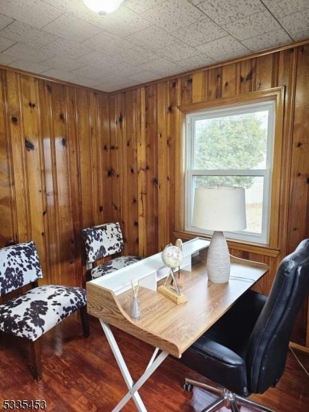 office area featuring hardwood / wood-style floors and wood walls