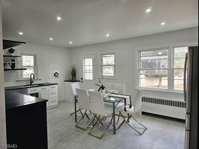 dining room featuring radiator and sink