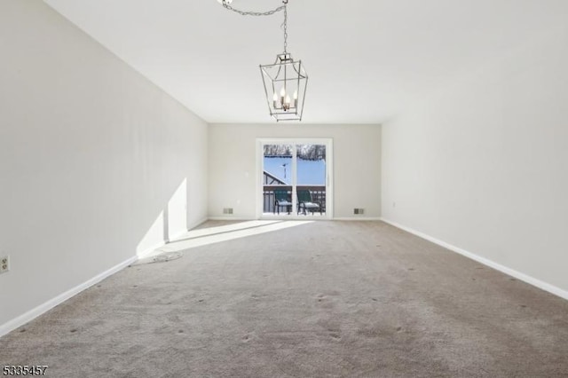 unfurnished living room with carpet floors and a notable chandelier