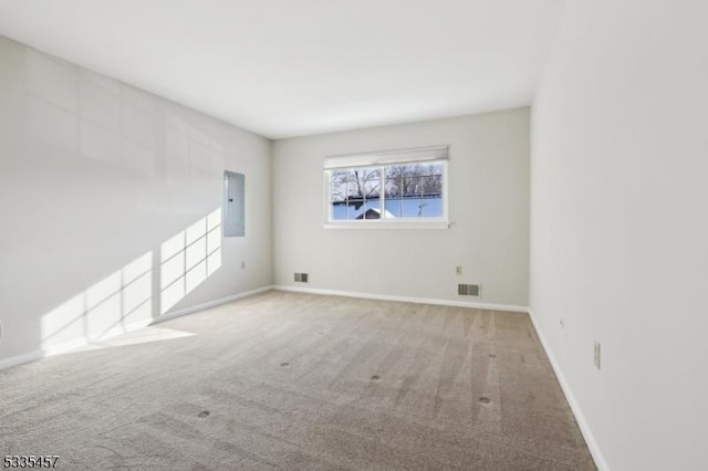 carpeted empty room with electric panel