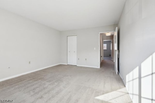 spare room featuring light colored carpet