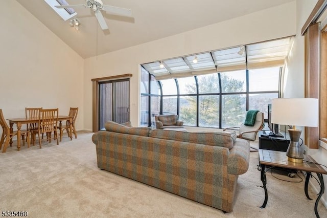 living room featuring ceiling fan, light colored carpet, and high vaulted ceiling