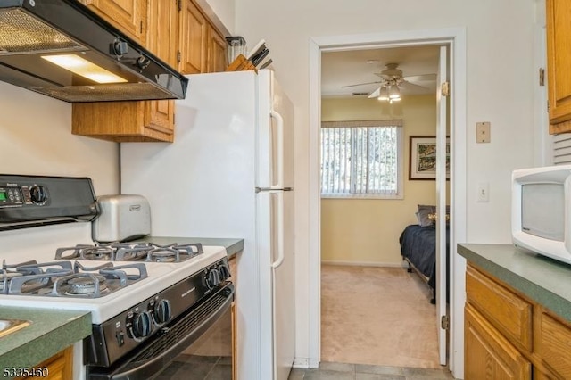 kitchen with extractor fan, light colored carpet, gas range oven, and ceiling fan