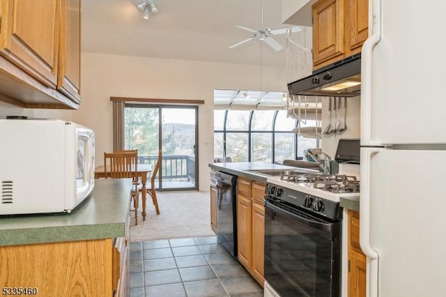 kitchen featuring ceiling fan, light tile patterned floors, and white appliances