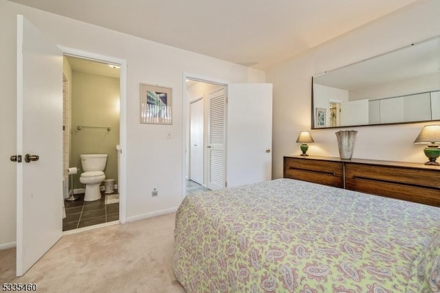 carpeted bedroom featuring ensuite bath