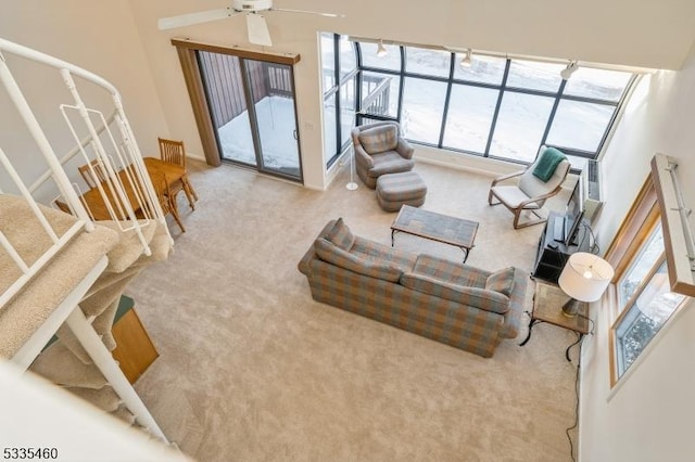 carpeted living room featuring ceiling fan