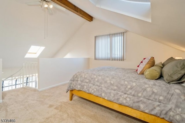 carpeted bedroom with lofted ceiling with skylight