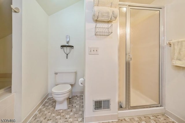 bathroom featuring toilet and walk in shower