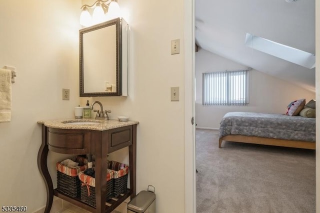 bedroom featuring lofted ceiling with skylight, sink, and light carpet