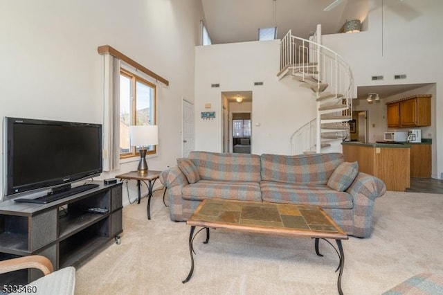 carpeted living room featuring a high ceiling